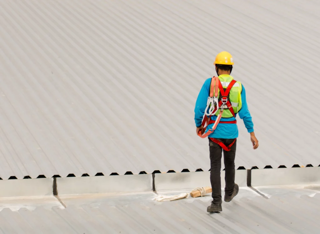 man walking on an asbestos ridden roof glendale az